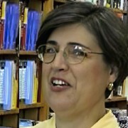 Woman with glasses and short dark hair